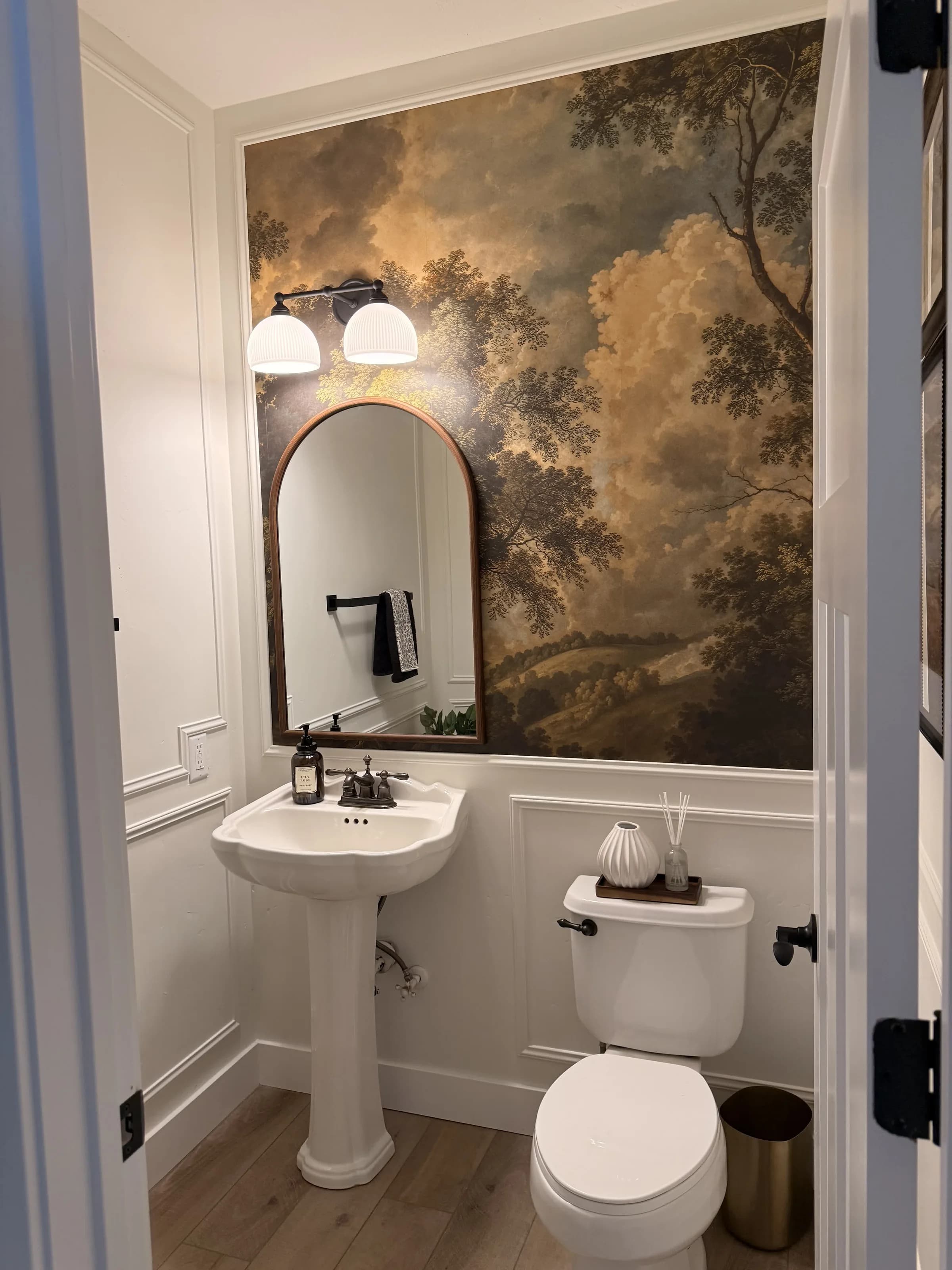Powder room with landscape wallpaper by BK Toolbox