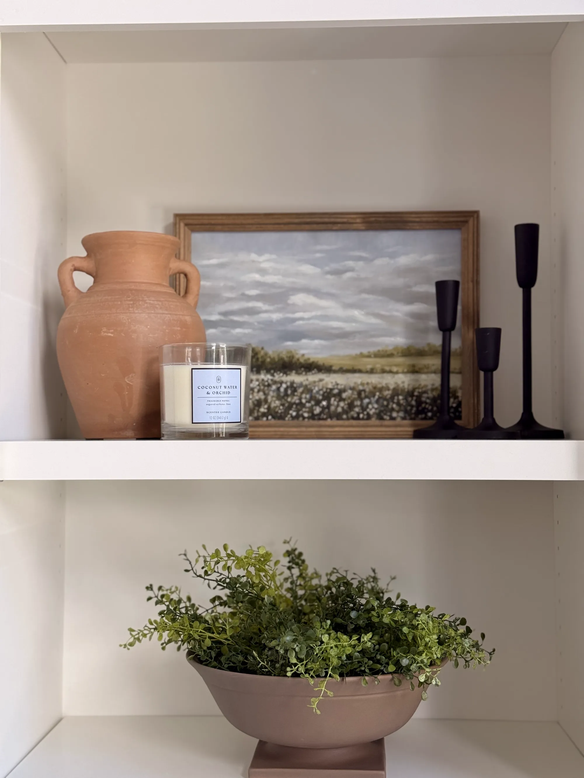 Styled shelf with terracotta vase and landscape art by BK Toolbox