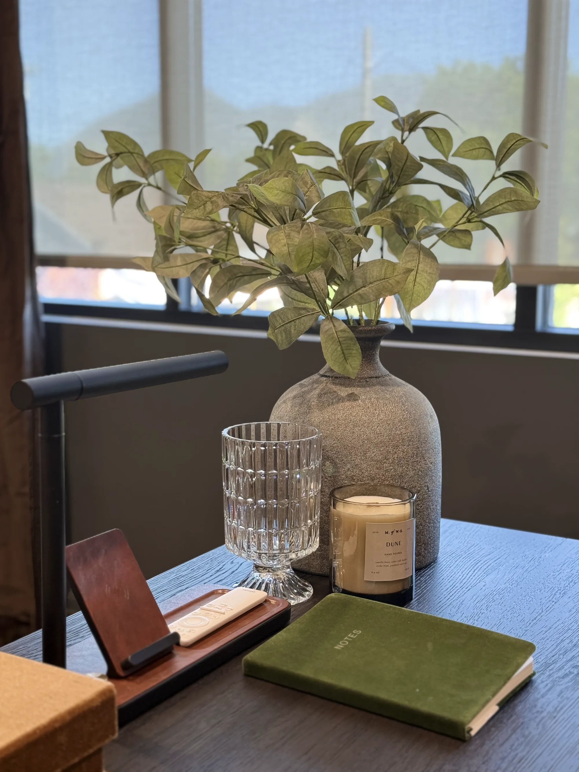 Home office desk styled with a task lamp, ceramic vase, and notebook by BK Toolbox